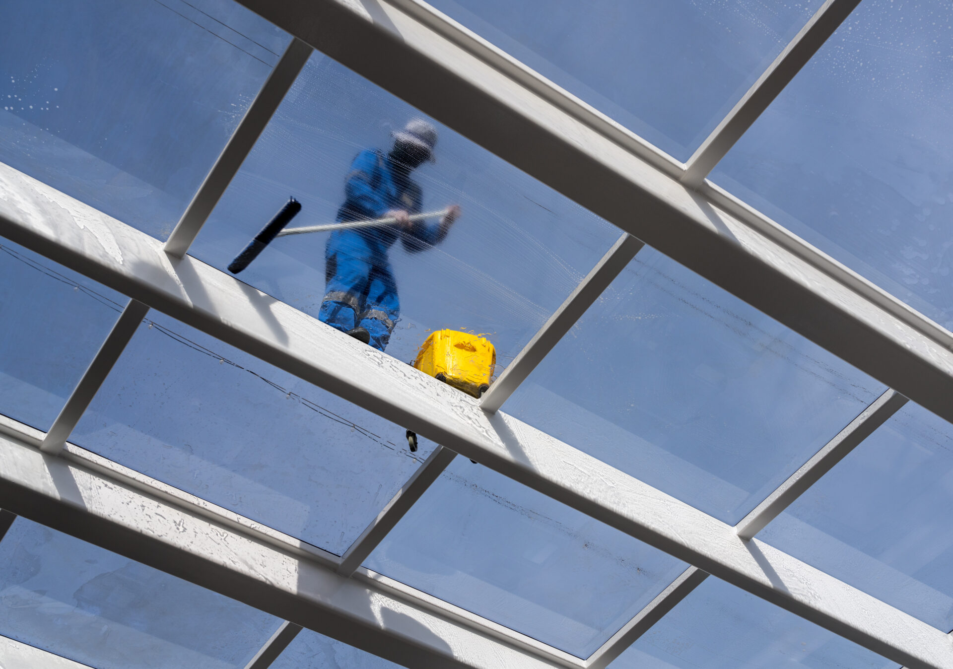 Man cleaning office windows for commercial spring cleaning.