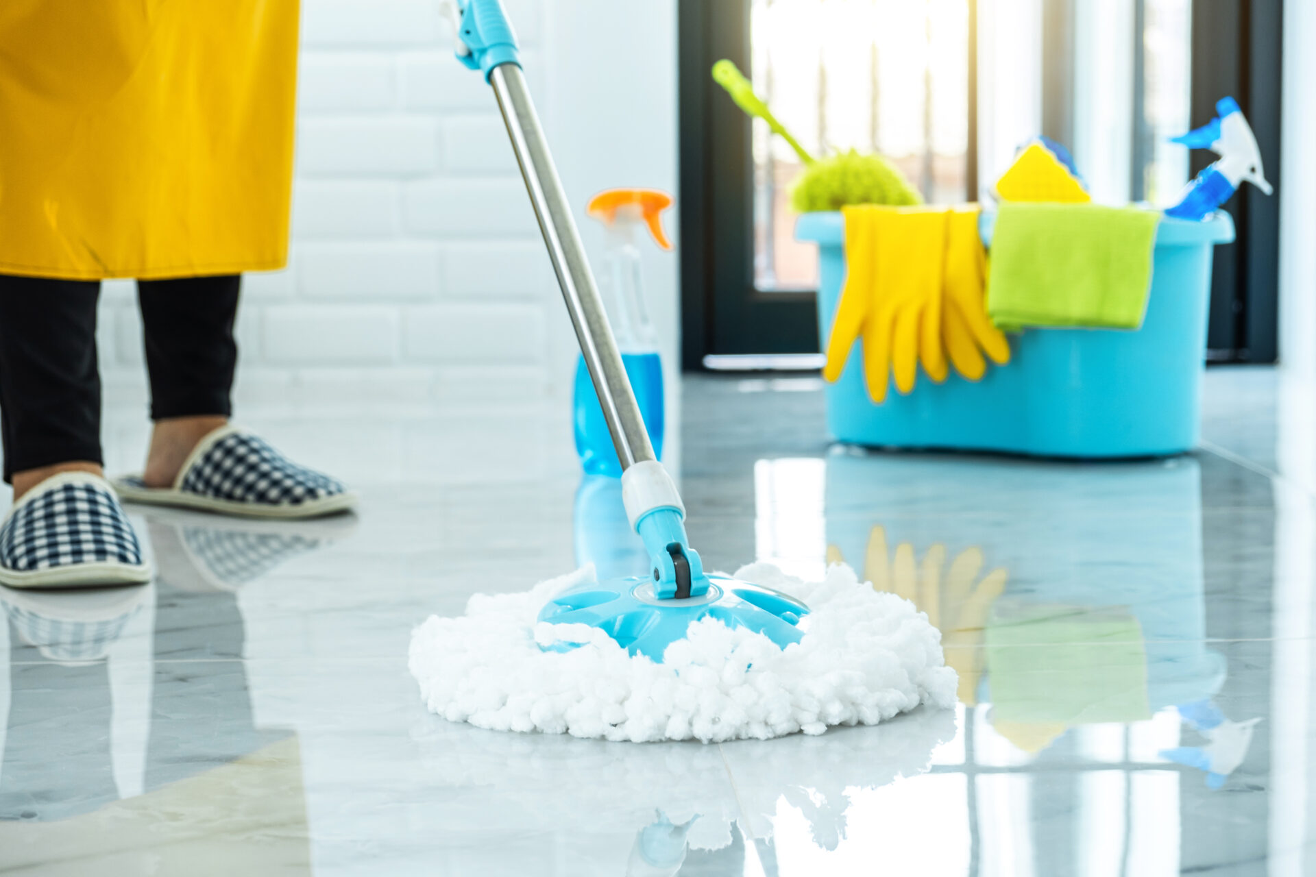 Wife housekeeping and cleaning concept, Happy young woman in blue rubber gloves wiping dust using mop while cleaning on floor at home.