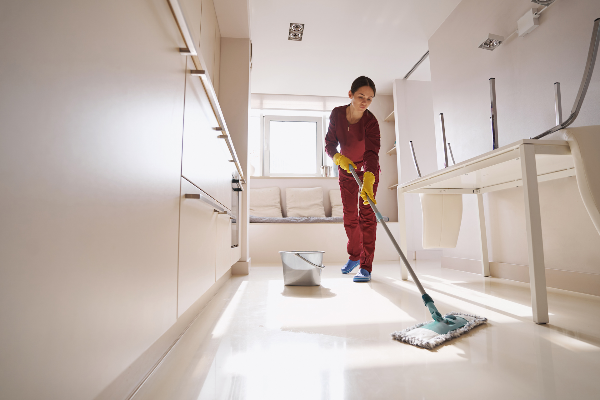 Janitorial services: a concentrated uniformed professional janitor doing wet cleaning